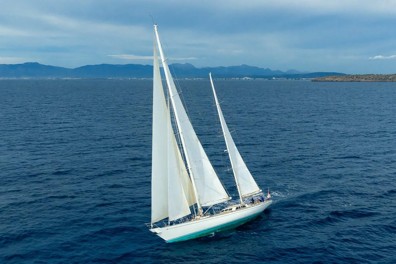 A stunning sailing yacht glides gracefully across the open sea with its sails fully unfurled. aboard TEMPEST Yacht for Sale