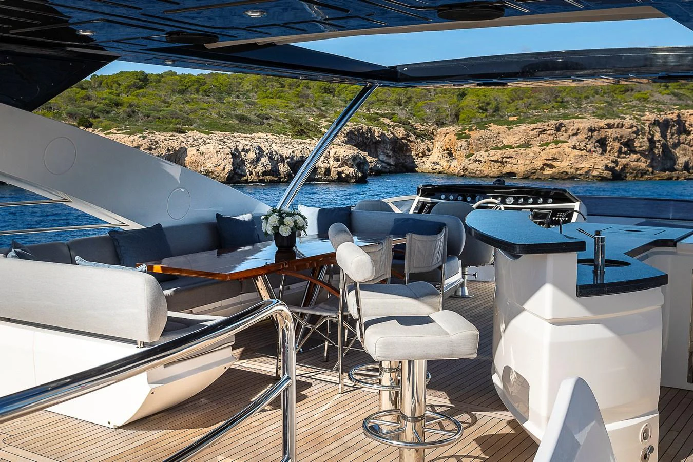 The flybridge offers a luxurious outdoor seating and dining area with stunning views of the surrounding waters. aboard THIS TIME NEXT YEAR Yacht for Sale
