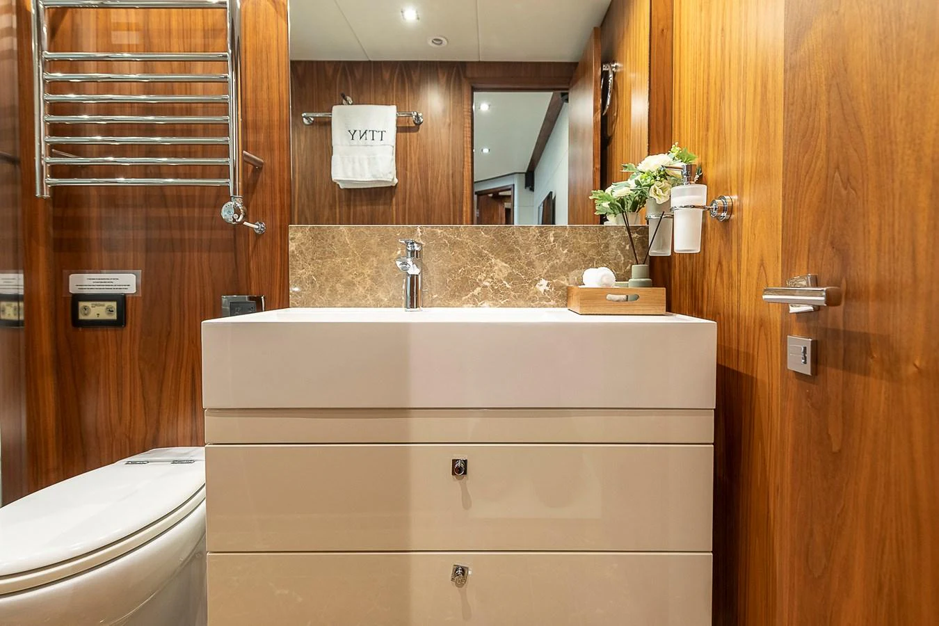 A well-appointed yacht bathroom with modern fixtures and warm wood accents. aboard THIS TIME NEXT YEAR Yacht for Sale
