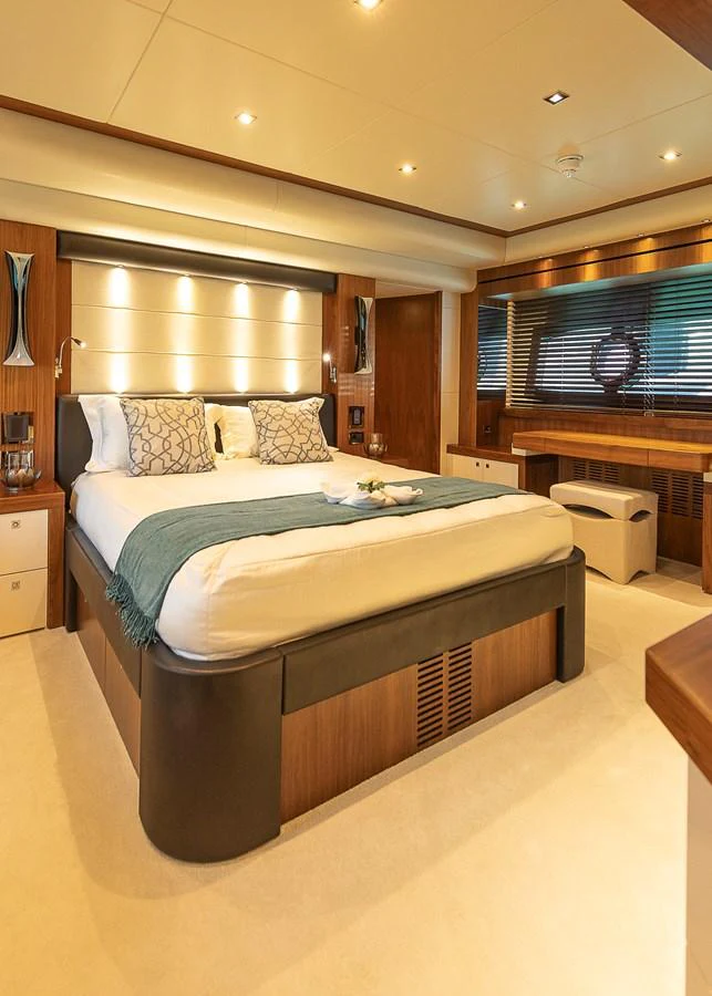 The master stateroom features a luxurious bed with elegant decor and ample natural light. aboard THIS TIME NEXT YEAR Yacht for Sale