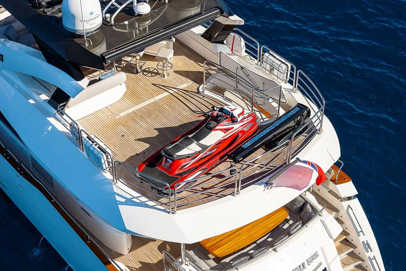 The yacht's aft deck features a sleek red jet ski and ample lounging space, perfect for water sports enthusiasts. aboard THIS TIME NEXT YEAR Yacht for Sale