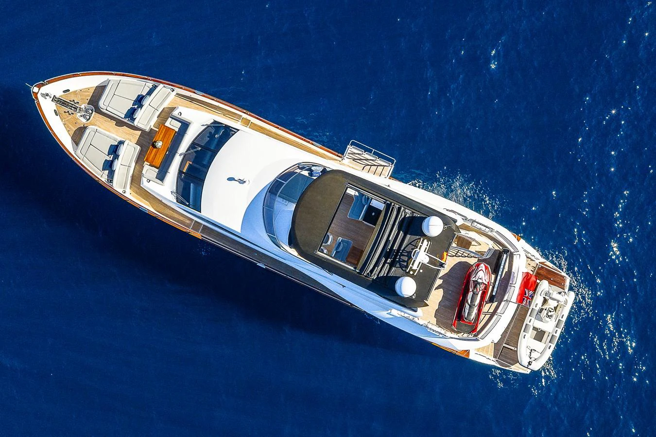 An aerial view of a luxurious yacht cruising through deep blue waters. aboard THIS TIME NEXT YEAR Yacht for Sale