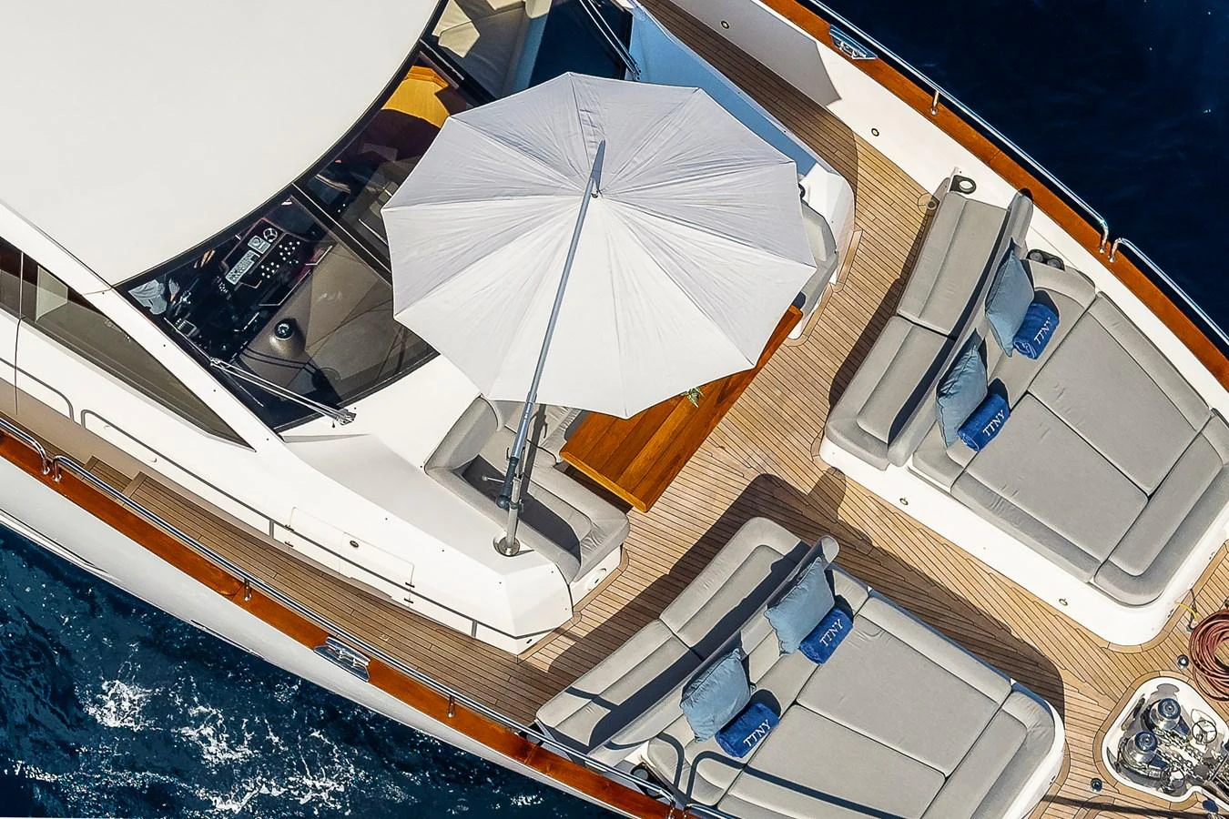 The flybridge features luxurious sun loungers and a large parasol for ultimate relaxation. aboard THIS TIME NEXT YEAR Yacht for Sale