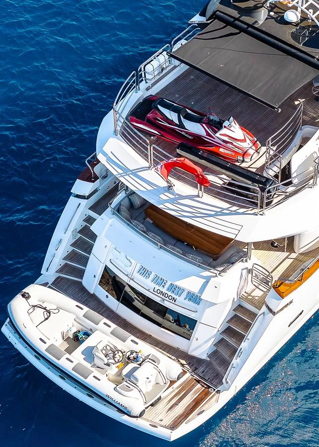 The yacht's aft deck features a tender and a jet ski, showcasing its readiness for water adventures. aboard THIS TIME NEXT YEAR Yacht for Sale