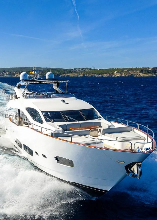 A sleek yacht cruises through the open water on a sunny day. aboard THIS TIME NEXT YEAR Yacht for Sale