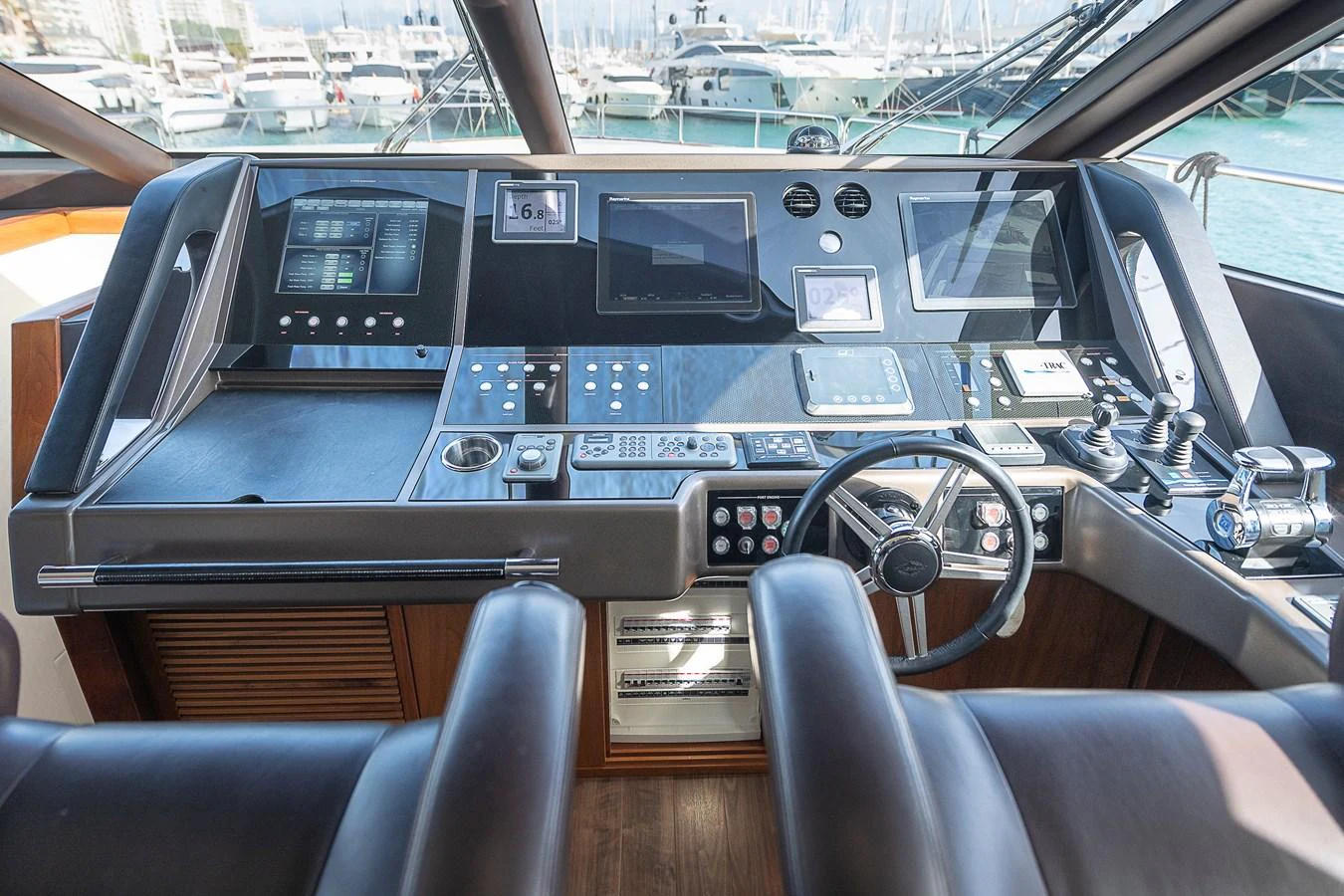 The helm station features advanced navigation equipment and a sleek, modern design. aboard THIS TIME NEXT YEAR Yacht for Sale