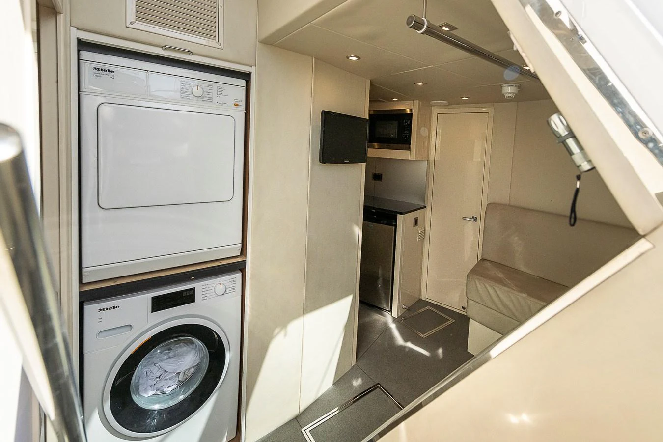The yacht's interior features a compact and efficient laundry area with modern appliances. aboard THIS TIME NEXT YEAR Yacht for Sale