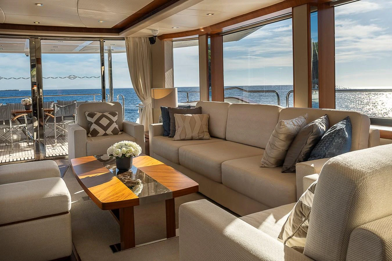 The salon offers a luxurious and comfortable space with panoramic ocean views. aboard THIS TIME NEXT YEAR Yacht for Sale