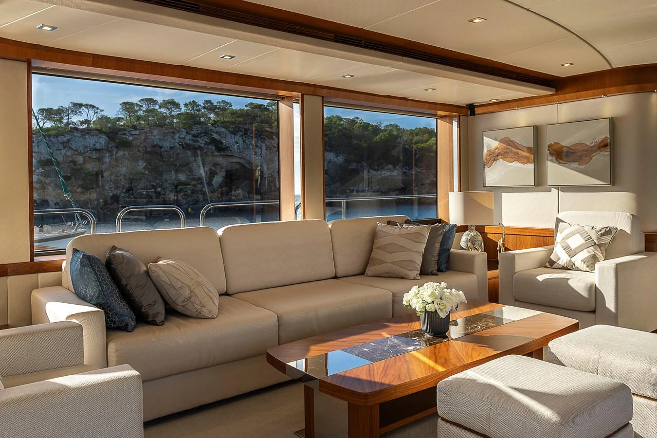 The salon offers a spacious and elegant seating area with large windows providing stunning views. aboard THIS TIME NEXT YEAR Yacht for Sale