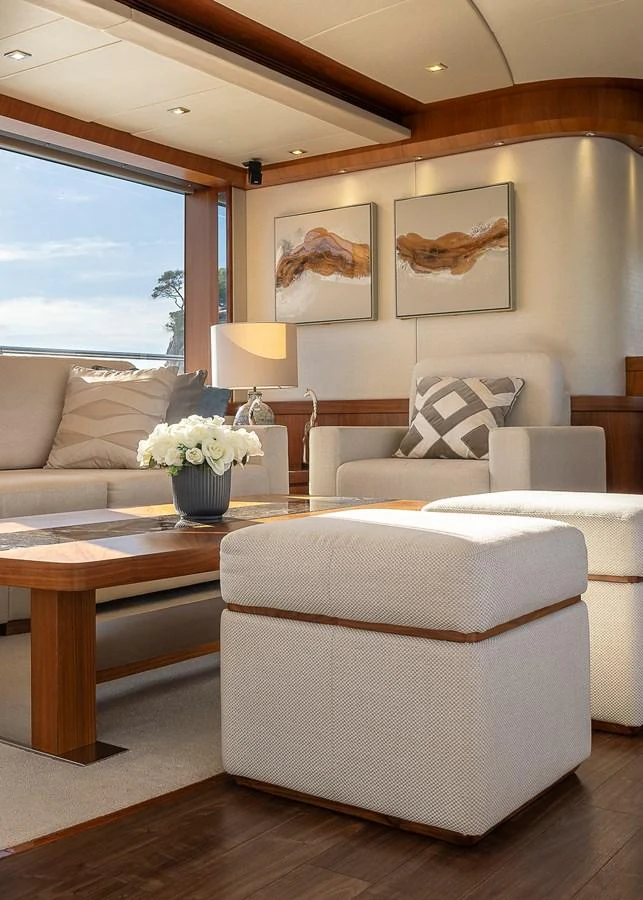 The salon features elegant furnishings and large windows for natural light. aboard THIS TIME NEXT YEAR Yacht for Sale