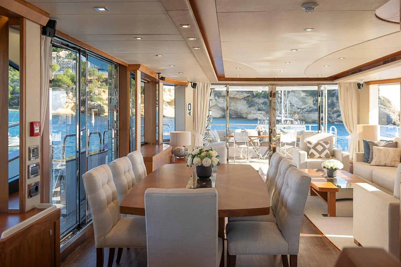 The yacht's salon offers a spacious and elegant setting with large windows providing stunning views of the surrounding waters. aboard THIS TIME NEXT YEAR Yacht for Sale