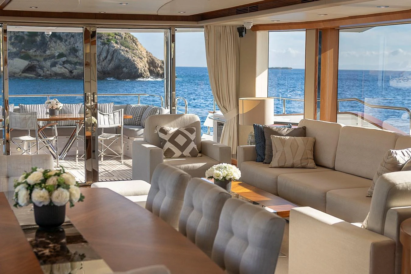 The salon offers a luxurious and comfortable space with stunning ocean views through large windows. aboard THIS TIME NEXT YEAR Yacht for Sale