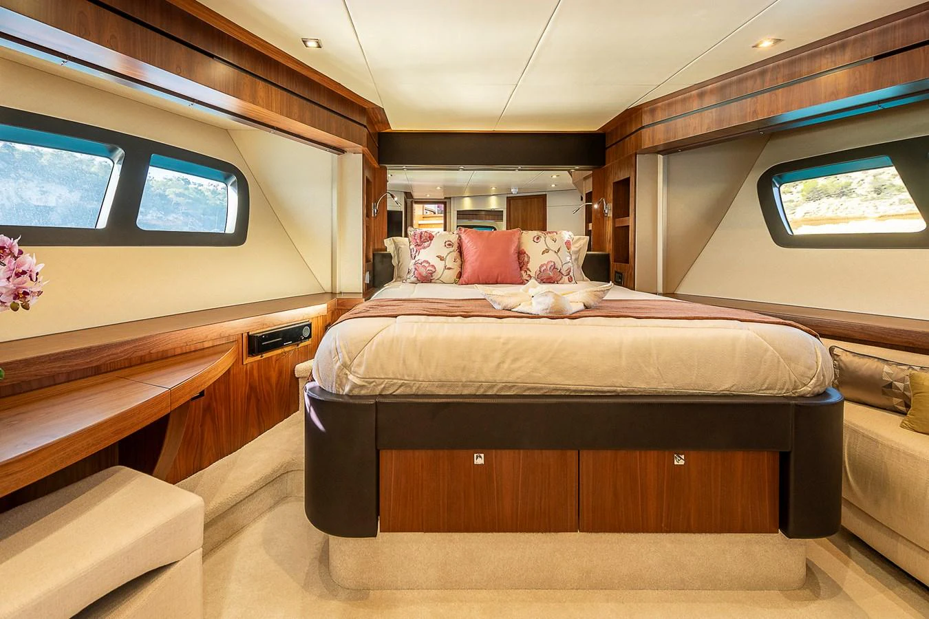 The master stateroom features a luxurious bed with elegant decor and ample natural light from the large windows. aboard THIS TIME NEXT YEAR Yacht for Sale