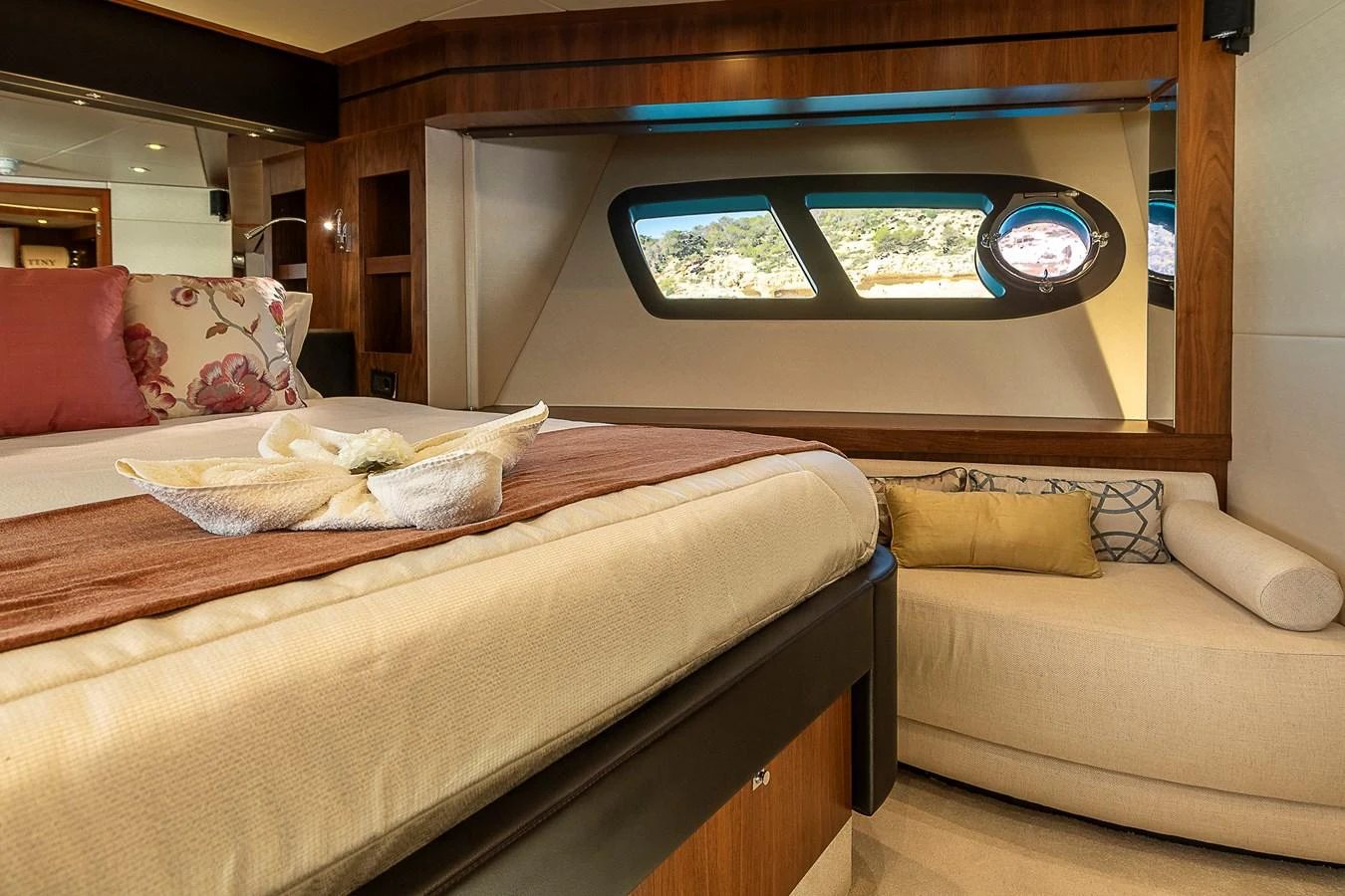 The stateroom offers a cozy and elegant retreat with a large bed and scenic window views. aboard THIS TIME NEXT YEAR Yacht for Sale