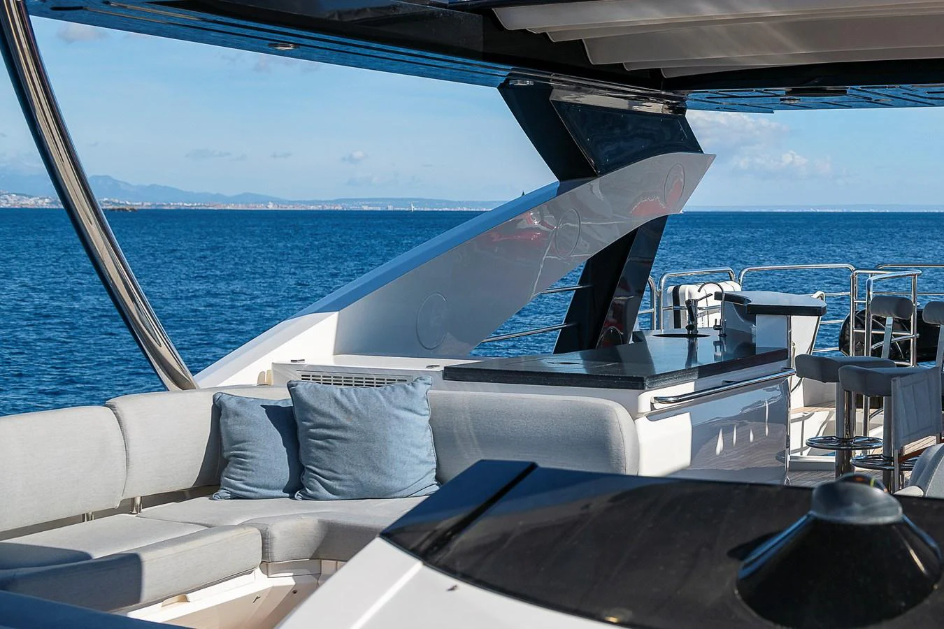 The flybridge offers a luxurious outdoor seating area with stunning ocean views. aboard THIS TIME NEXT YEAR Yacht for Sale