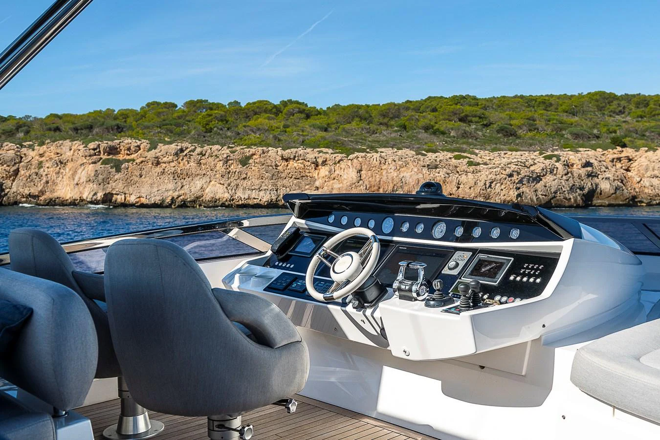 The helm station offers a commanding view of the surrounding waters and rugged coastline. aboard THIS TIME NEXT YEAR Yacht for Sale