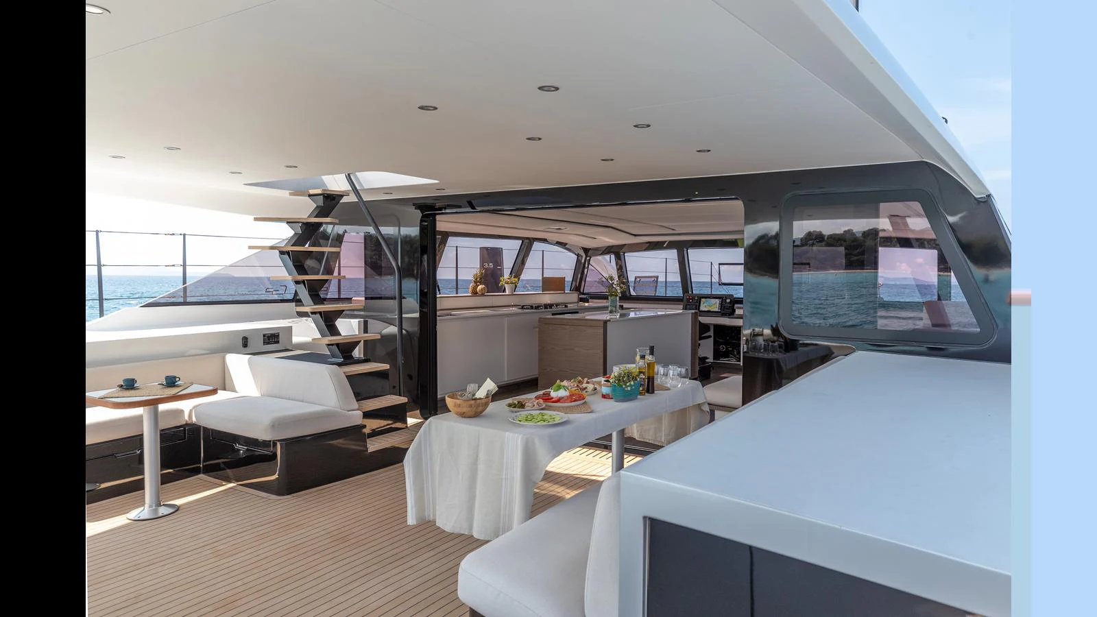 a room with a table and a couch aboard GUNBOAT 72 Yacht for Sale