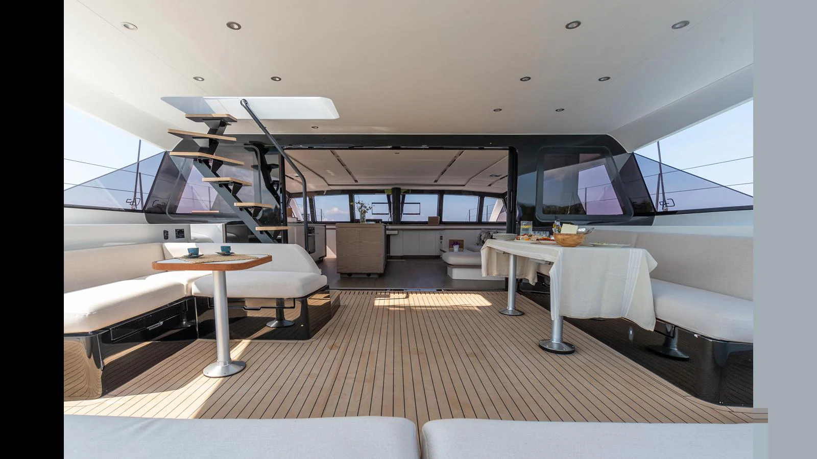 a room with tables and chairs aboard GUNBOAT 72 Yacht for Sale