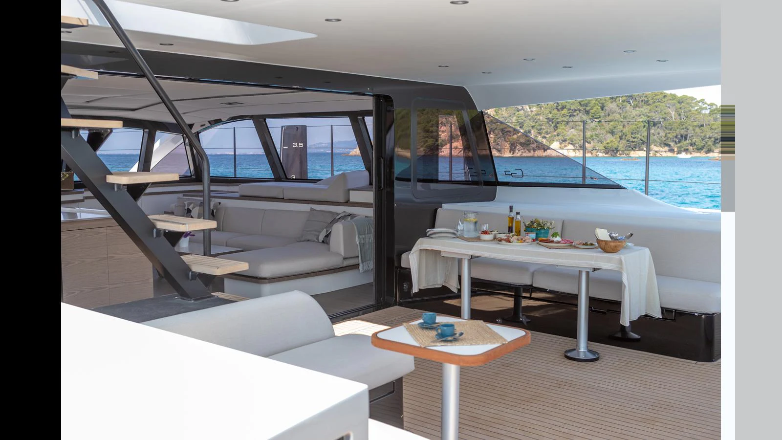 a room with a couch and a table and a pool aboard GUNBOAT 72 Yacht for Sale