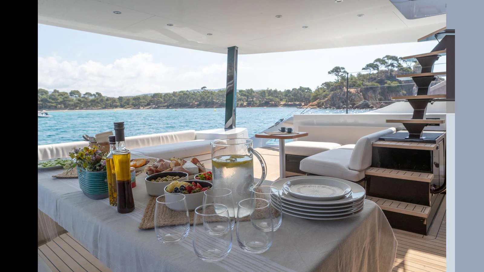 a table with food and drinks on it aboard GUNBOAT 72 Yacht for Sale