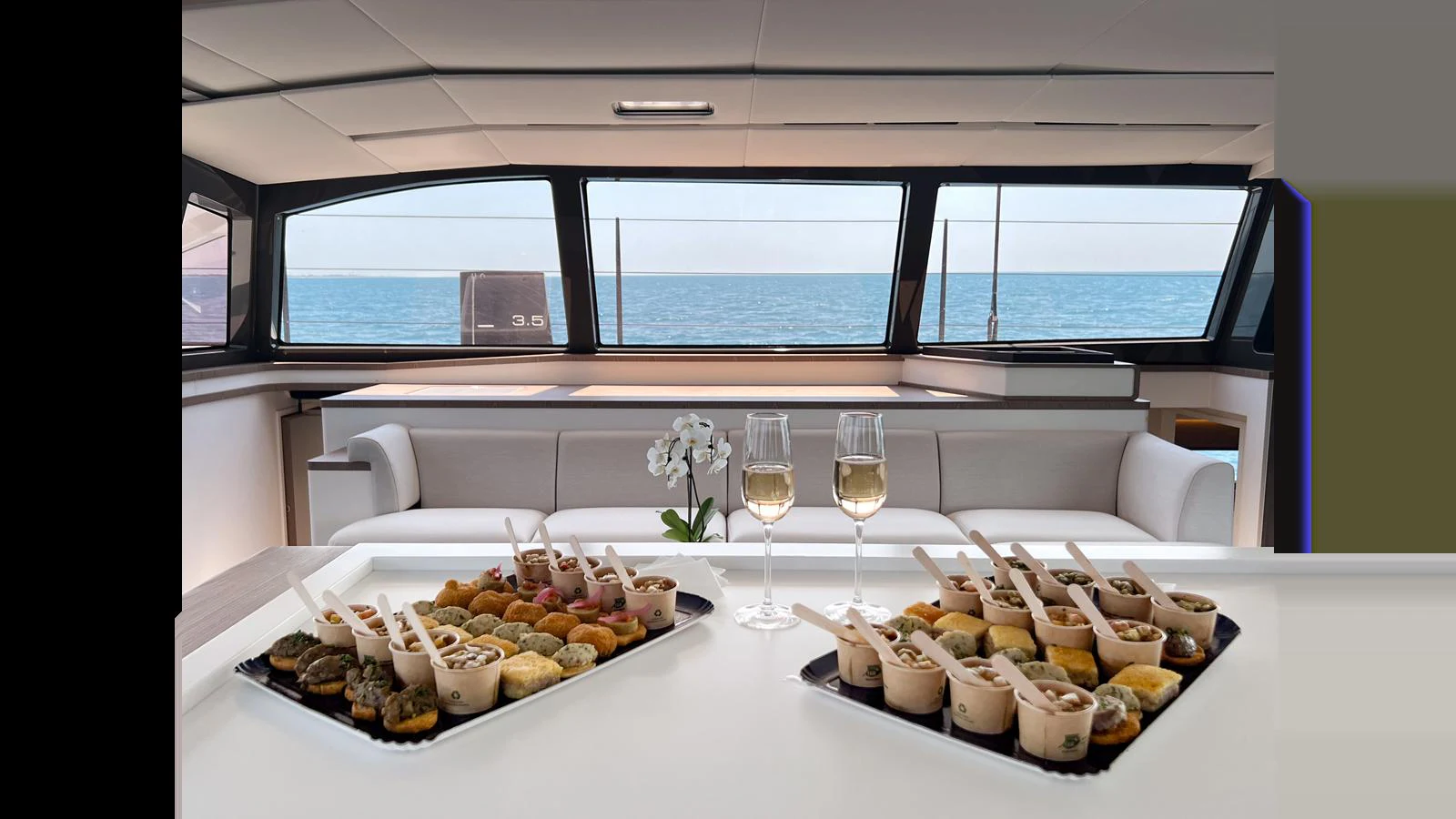 a table with food and wine aboard GUNBOAT 72 Yacht for Sale