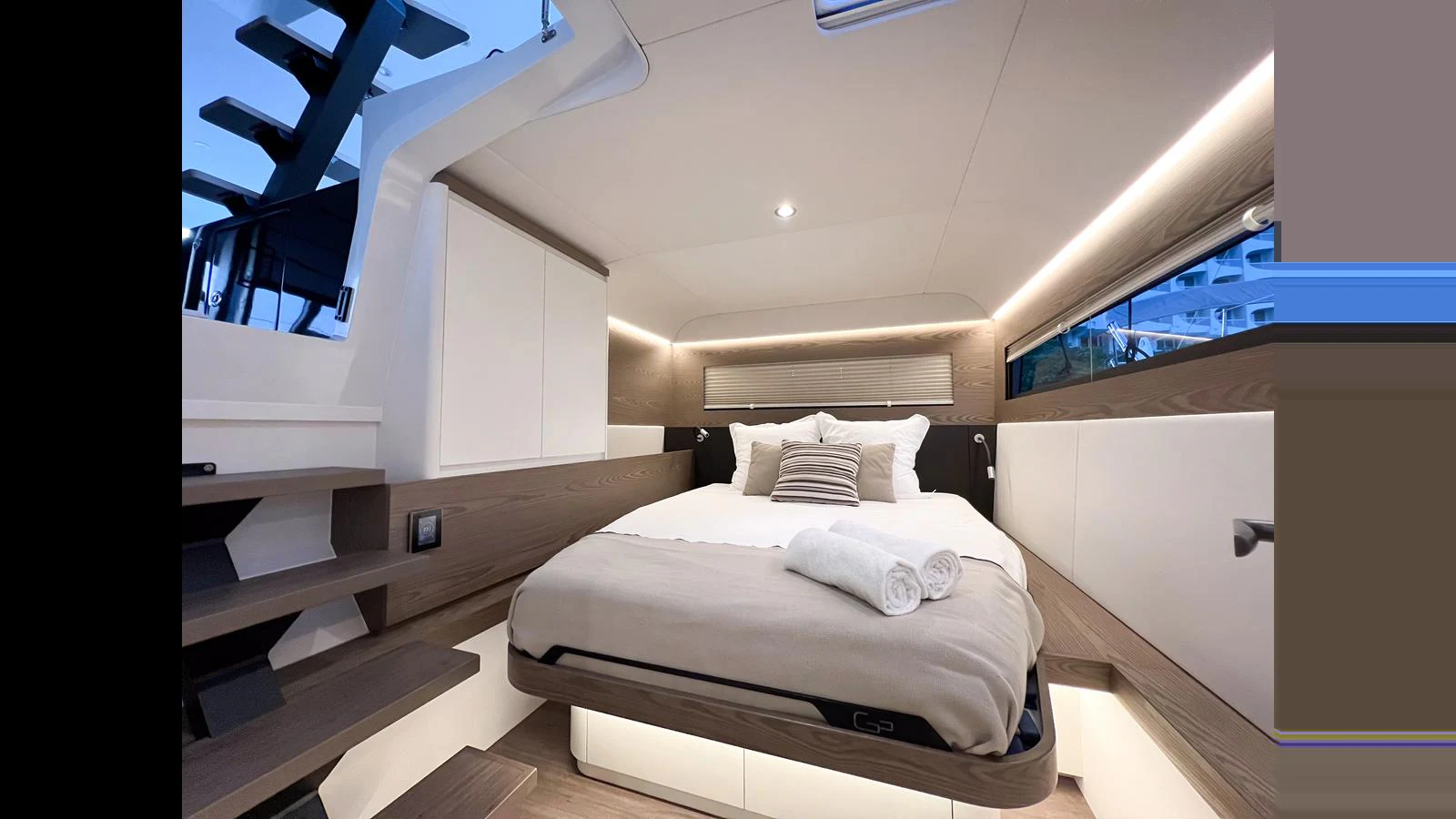 a room with a bed and a staircase aboard GUNBOAT 72 Yacht for Sale