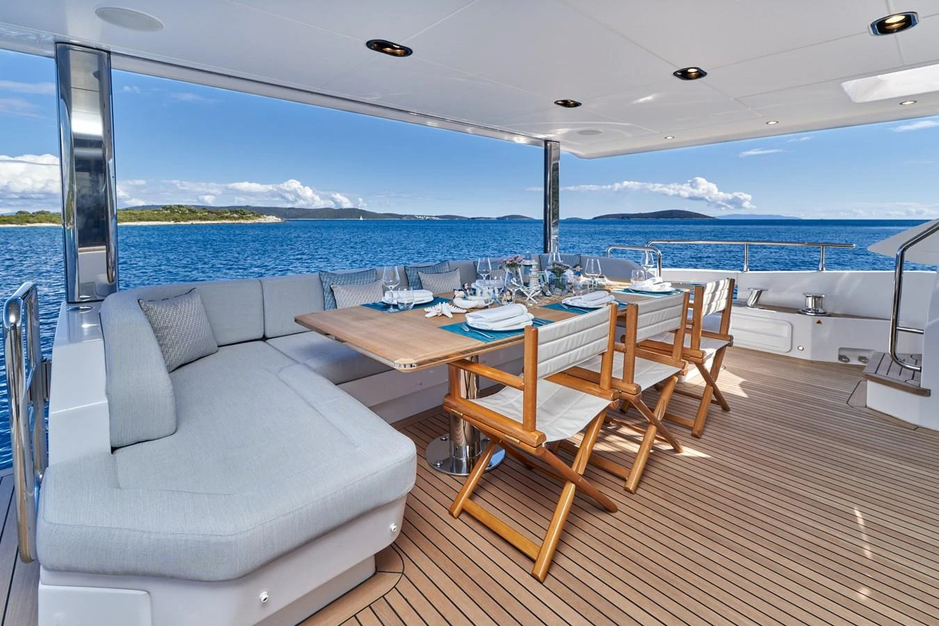 a room with a couch and a table and chairs aboard ALUMINIA TOO Yacht for Sale
