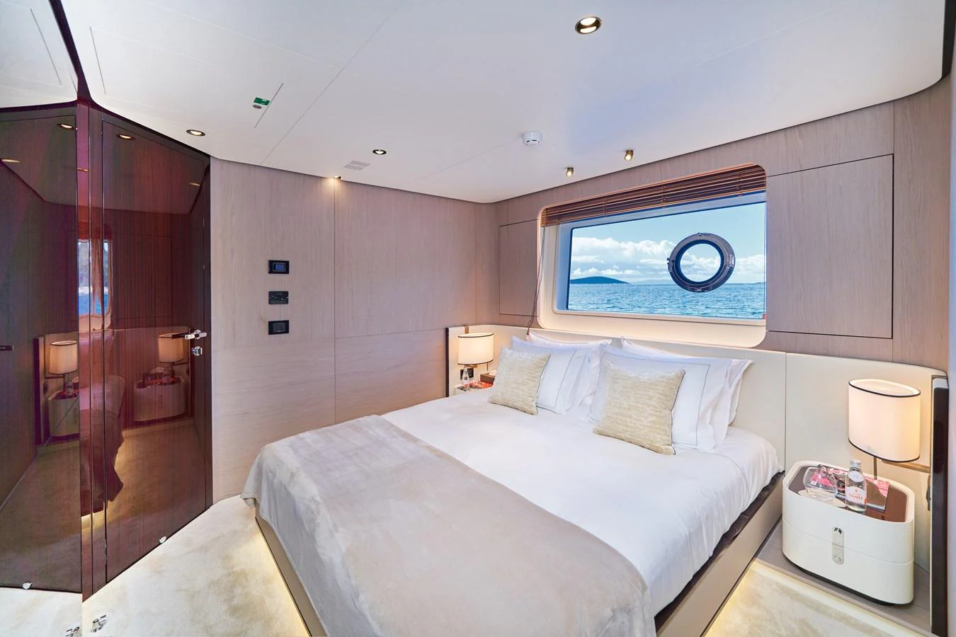 a bedroom with a bed and a mirror aboard ALUMINIA TOO Yacht for Sale