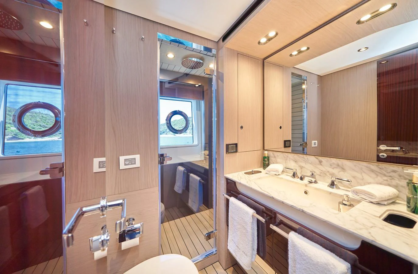 a bathroom with a large mirror aboard ALUMINIA TOO Yacht for Sale