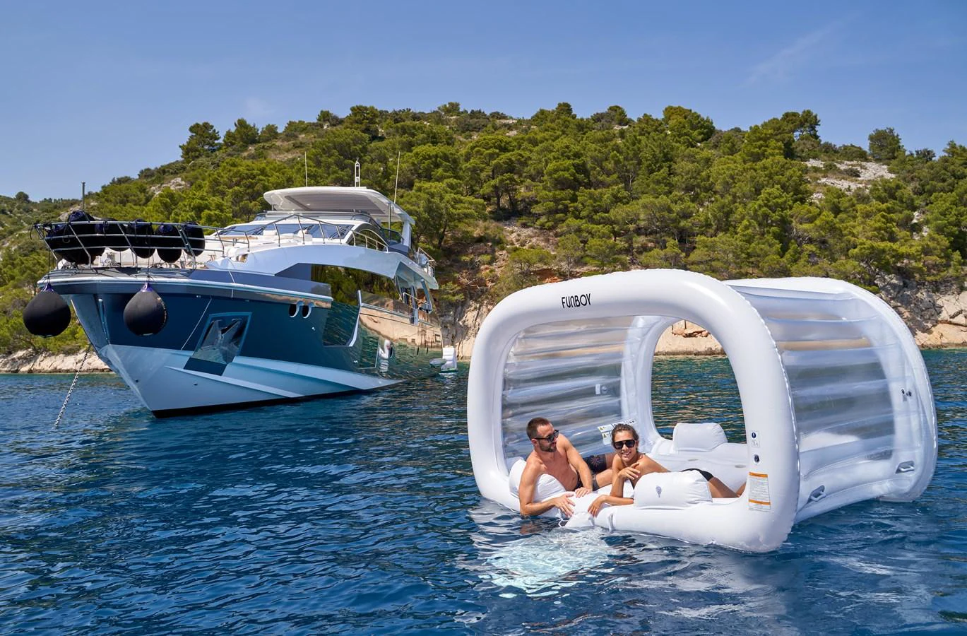 a man and a woman in a white boat on a beach aboard ALUMINIA TOO Yacht for Sale