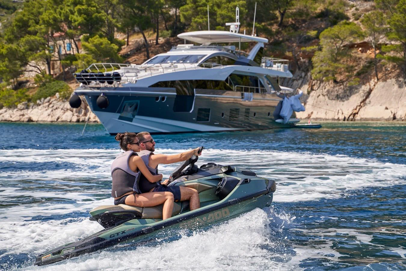 a man and woman on a jet ski in the water aboard ALUMINIA TOO Yacht for Sale
