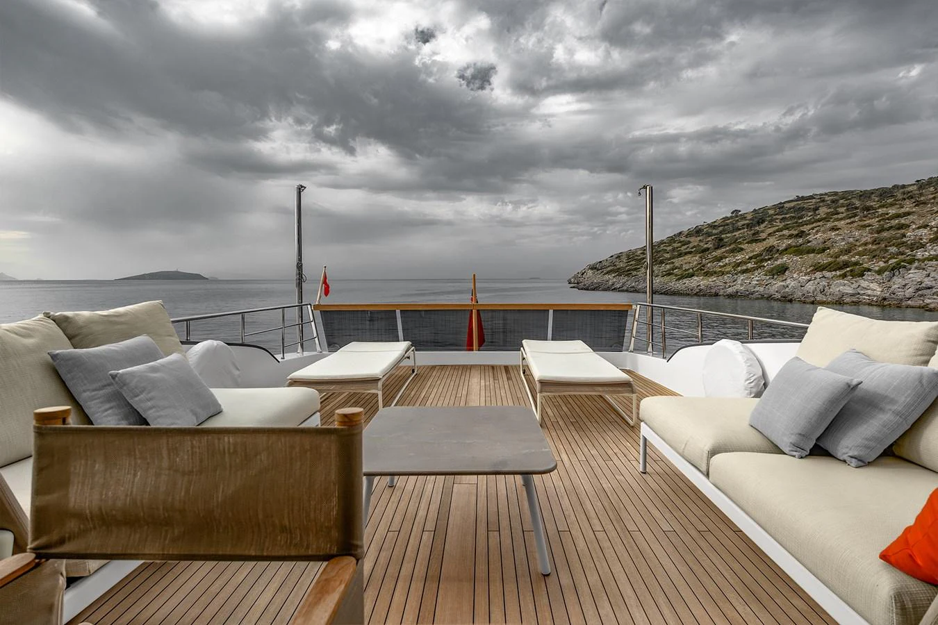 a deck with chairs and a body of water in the background aboard JOURNEY Yacht for Sale