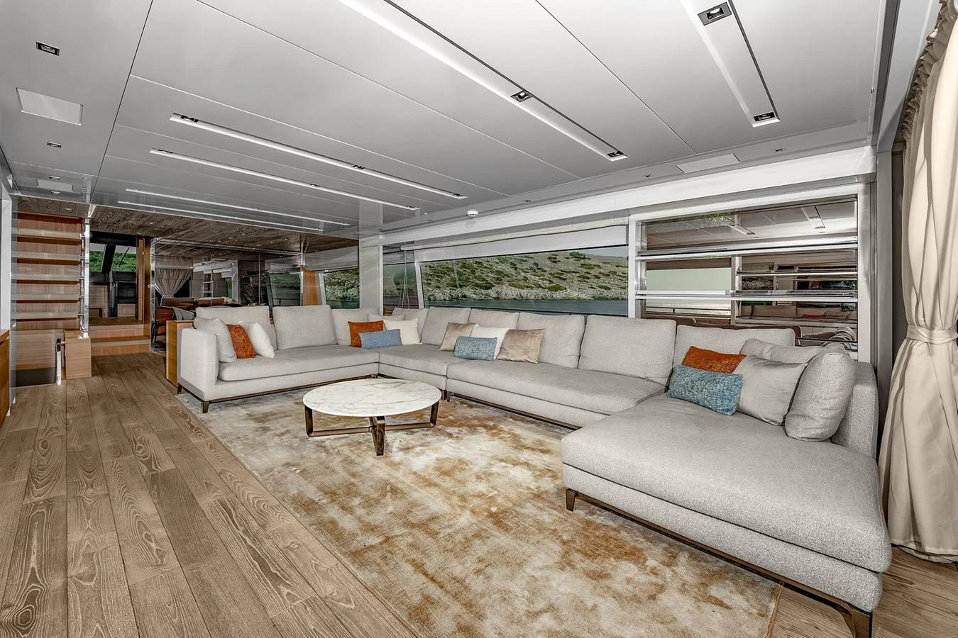 a large living room with a large rug and a large rug aboard JOURNEY Yacht for Sale