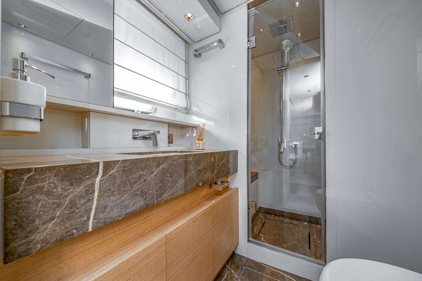 a bathroom with a glass shower aboard JOURNEY Yacht for Sale