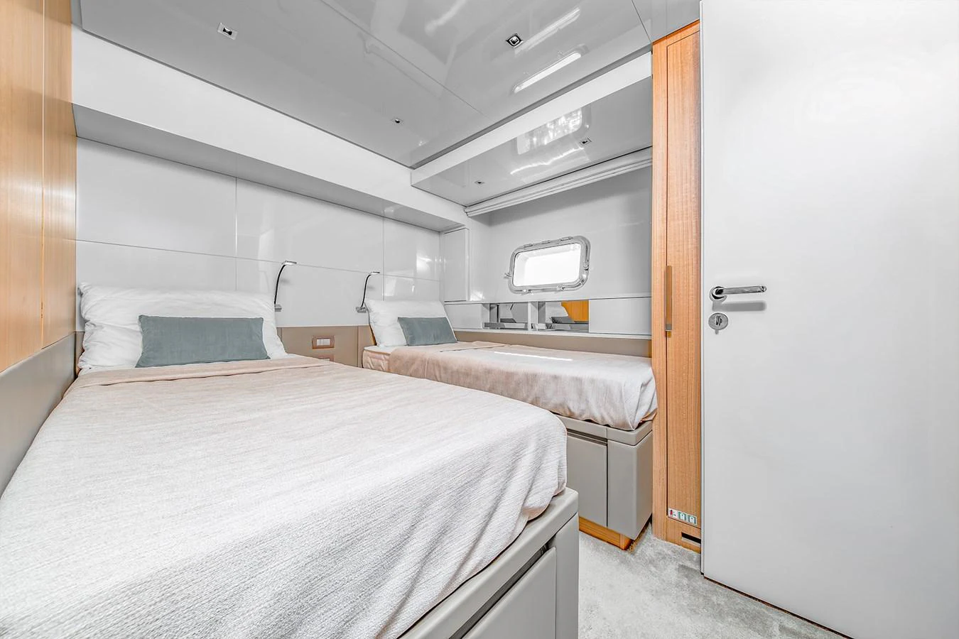 a room with beds and a door aboard JOURNEY Yacht for Sale