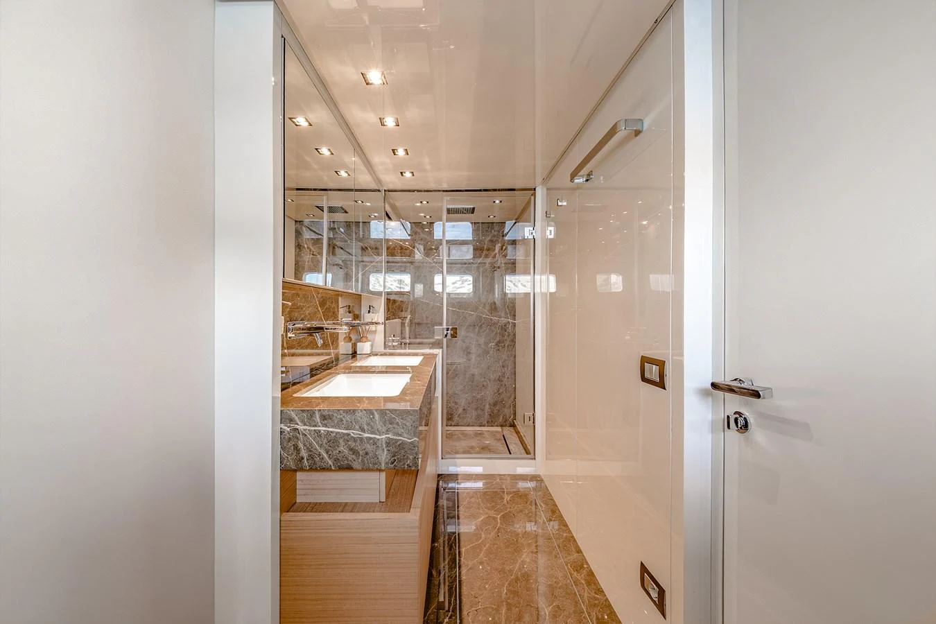 a bathroom with a large mirror aboard JOURNEY Yacht for Sale