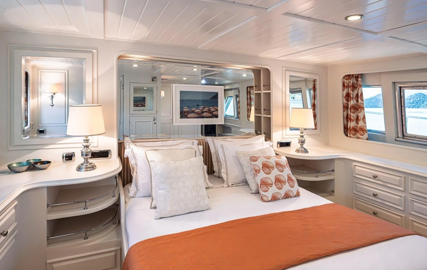 The master stateroom features a luxurious bed with elegant decor and ample natural light. aboard LADY L Yacht for Sale
