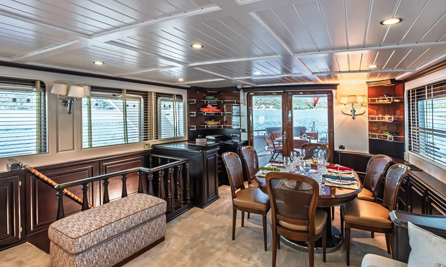 The yacht's dining area features elegant furnishings and ample natural light. aboard LADY L Yacht for Sale