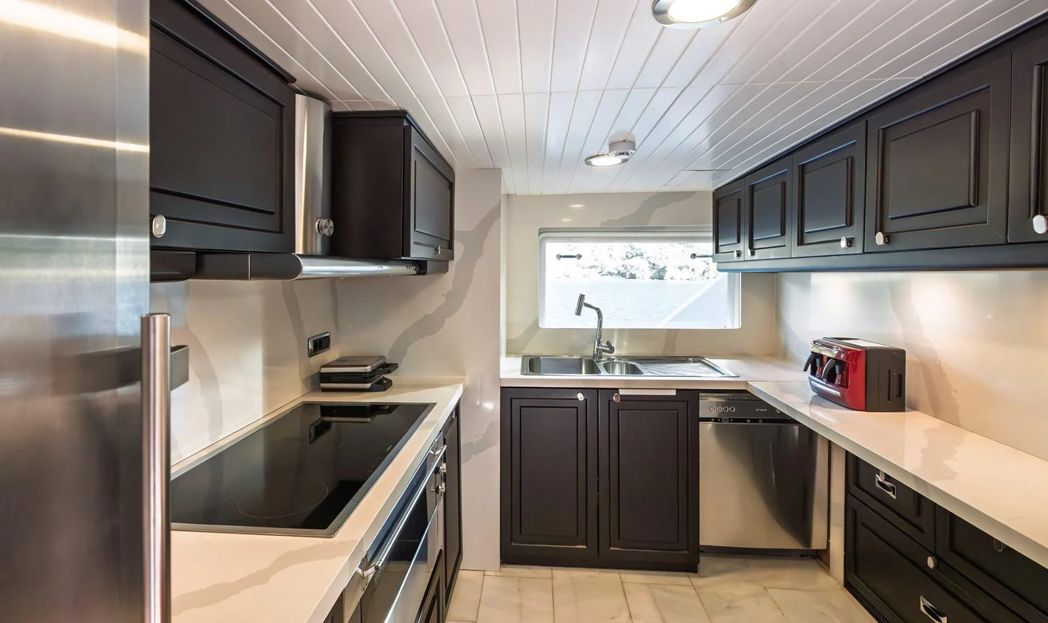 The yacht's galley features modern appliances and sleek cabinetry, creating a stylish and functional cooking space. aboard LADY L Yacht for Sale