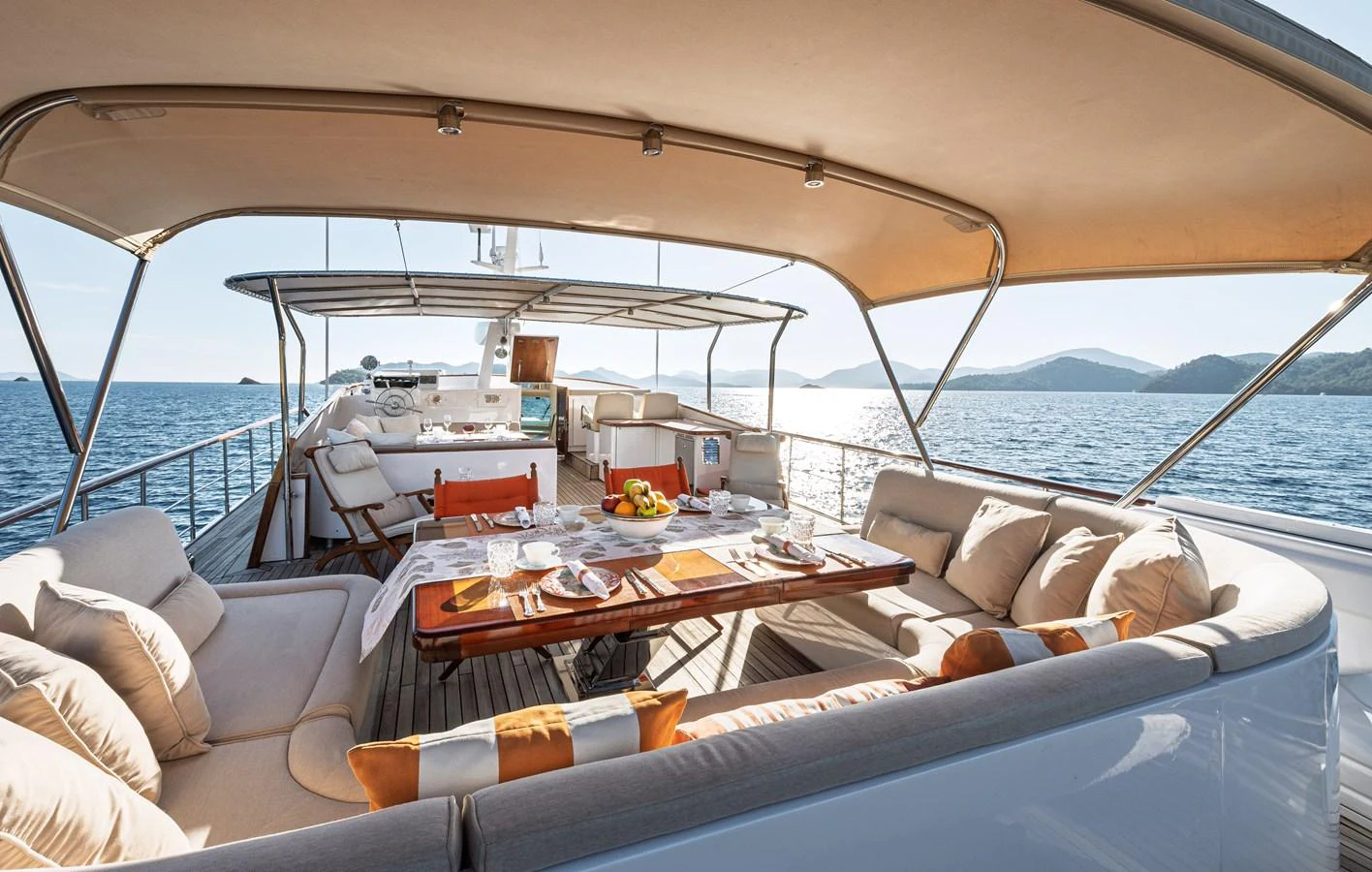 The sundeck offers a luxurious outdoor dining area with comfortable seating and stunning sea views. aboard LADY L Yacht for Sale