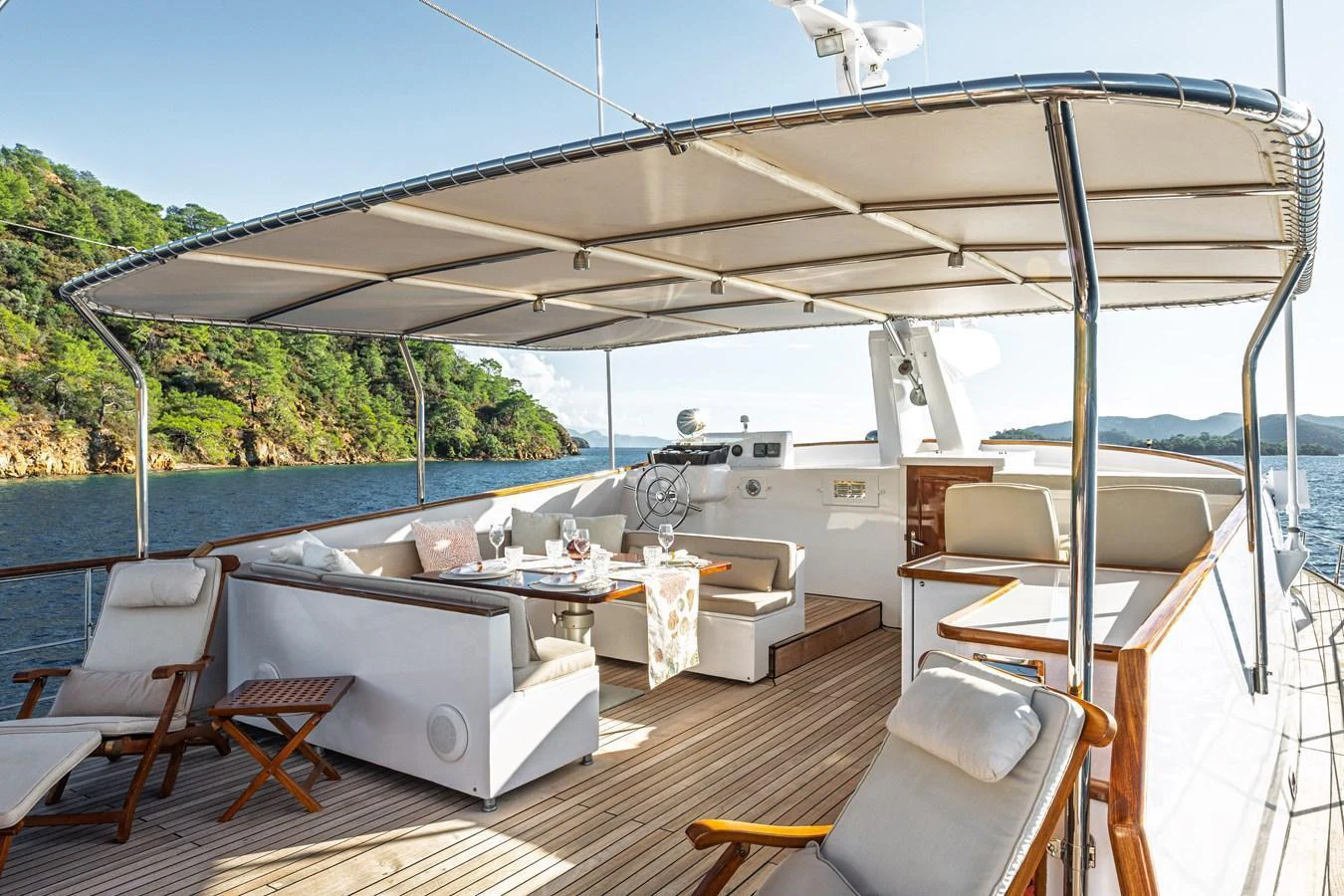 The flybridge offers a spacious and comfortable outdoor seating area with stunning views. aboard LADY L Yacht for Sale