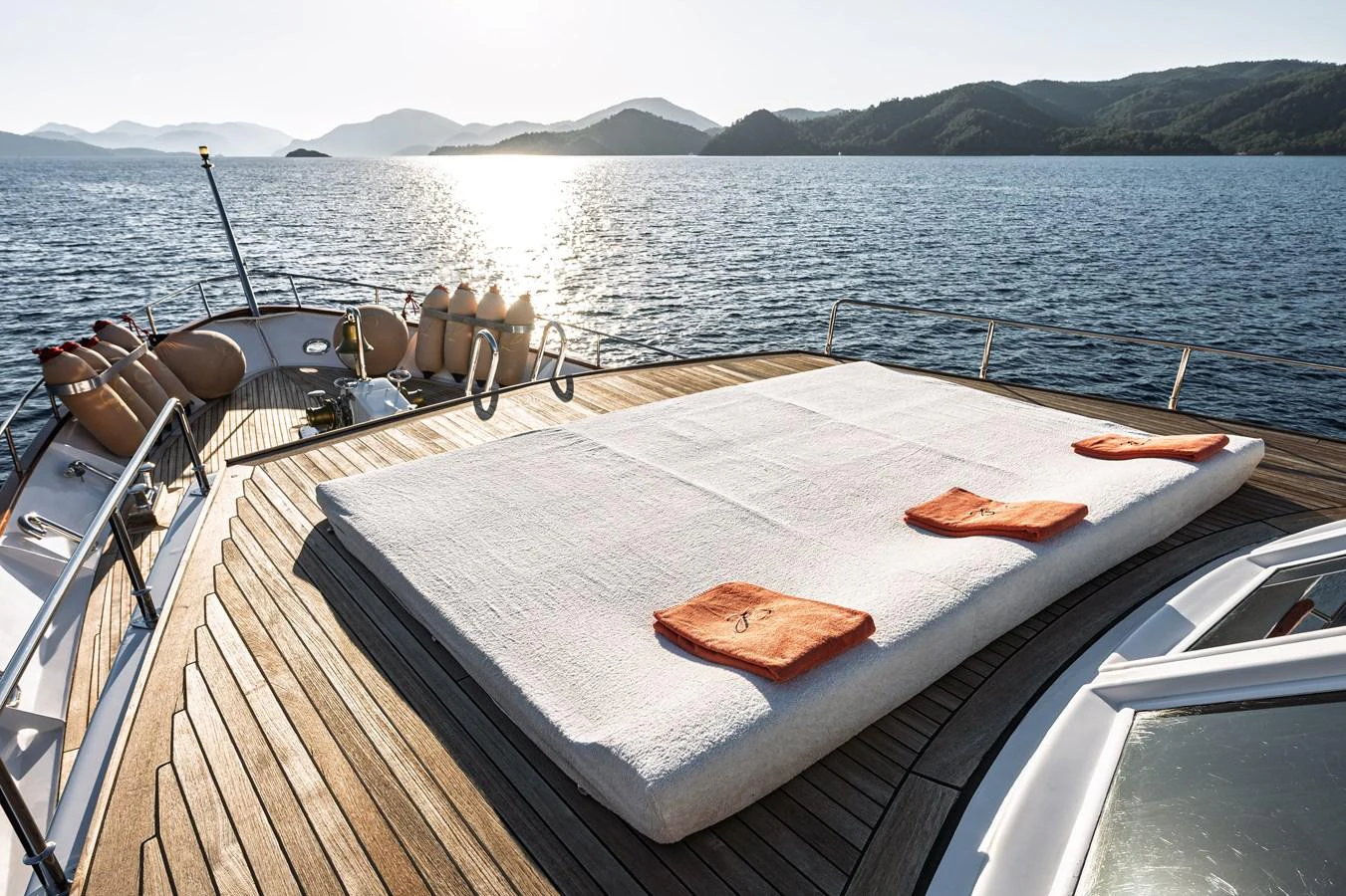 The sundeck features a spacious sunbathing area with plush cushions and scenic ocean views. aboard LADY L Yacht for Sale