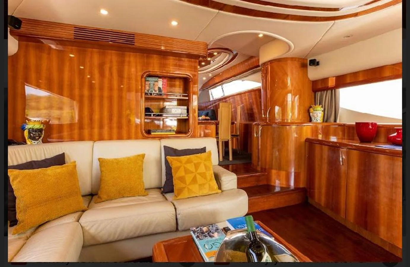 The yacht's interior features a luxurious seating area with plush cushions and polished wooden finishes. aboard STRADIVARIA Yacht for Sale