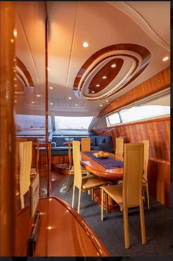 The yacht's dining area features elegant wooden finishes and ample seating for a luxurious dining experience. aboard STRADIVARIA Yacht for Sale