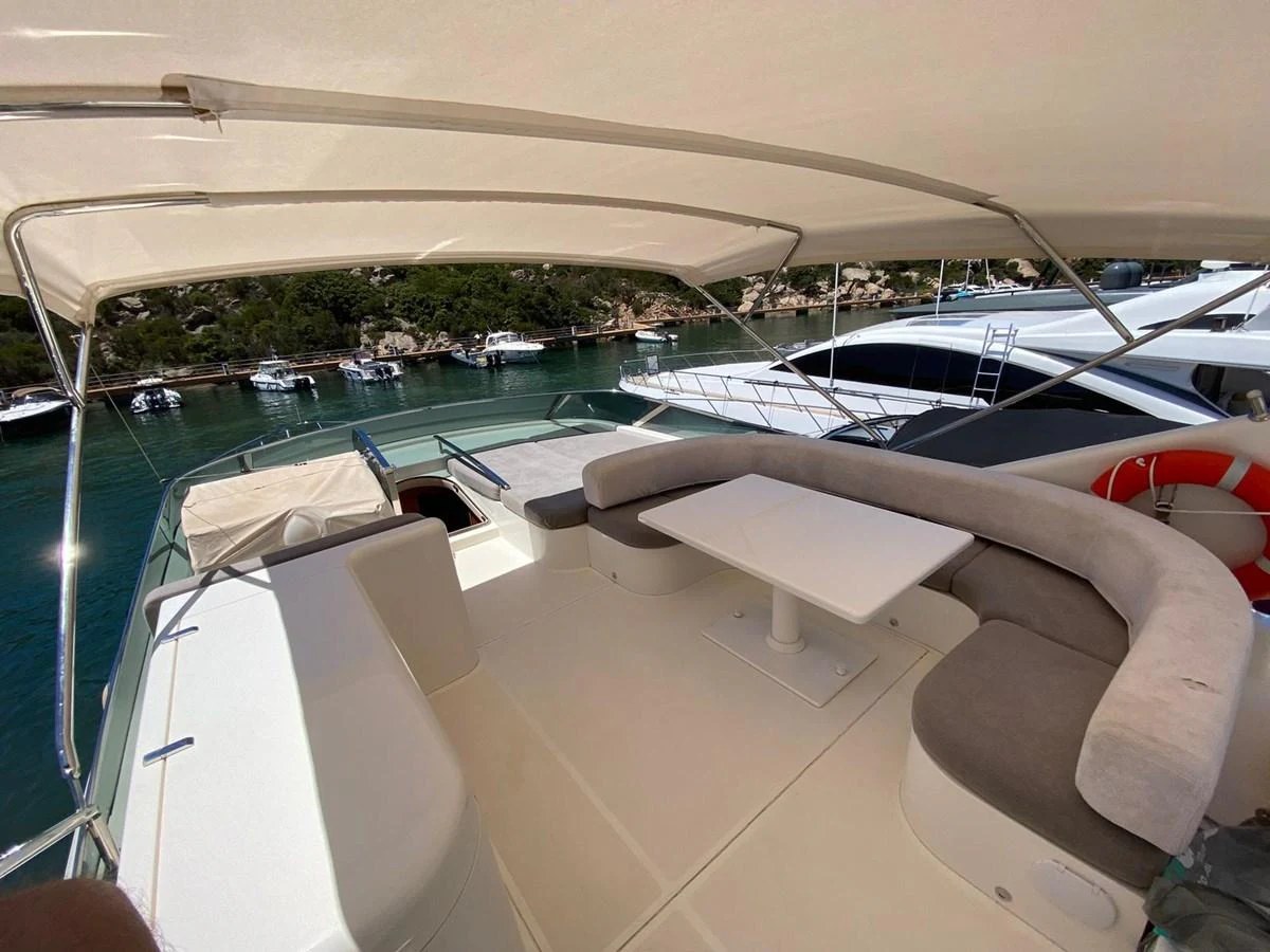 The flybridge offers a spacious seating area with a table, perfect for enjoying the views while cruising. aboard STRADIVARIA Yacht for Sale