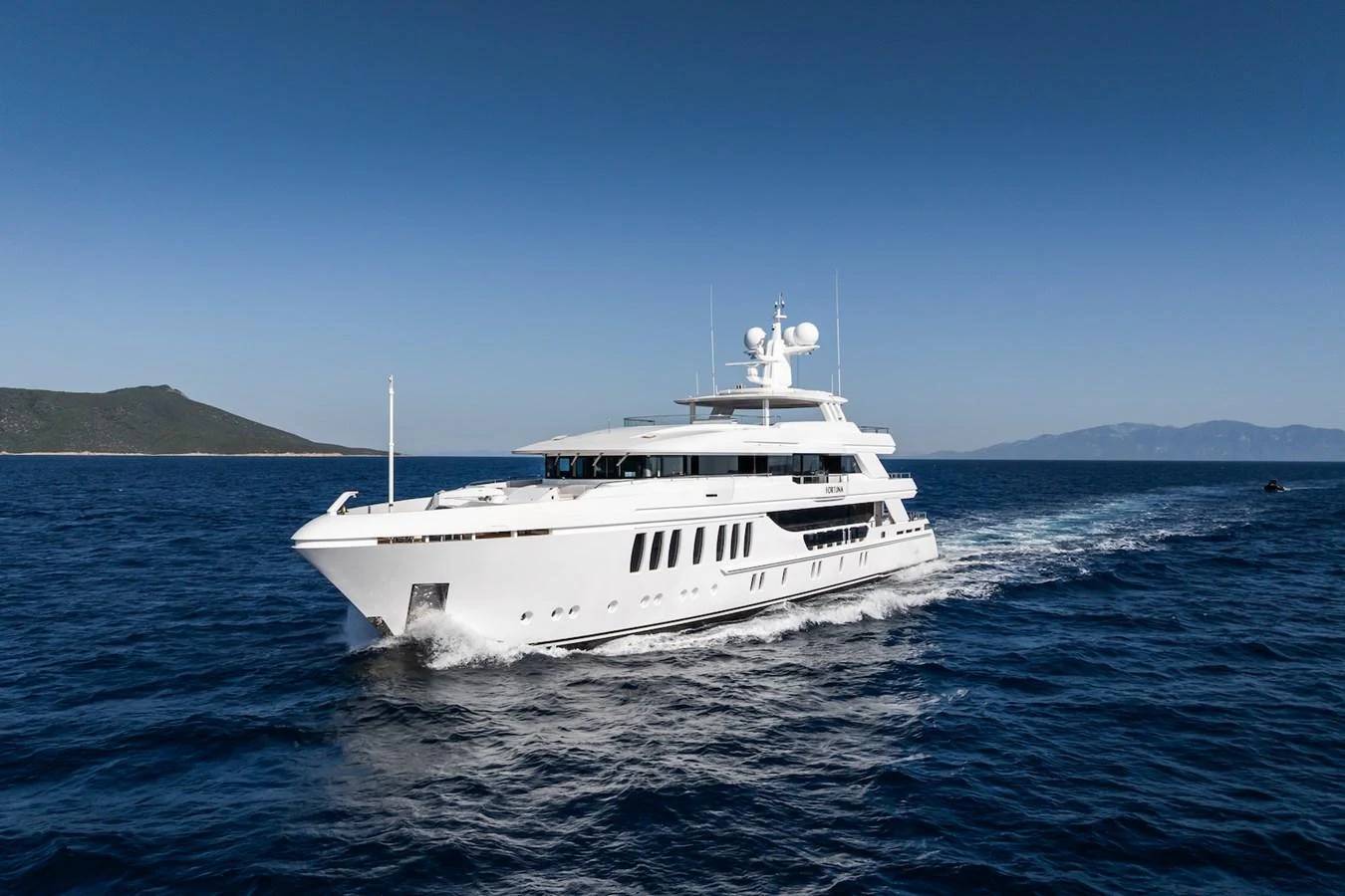 a white boat in the water aboard FORTUNA Yacht for Sale