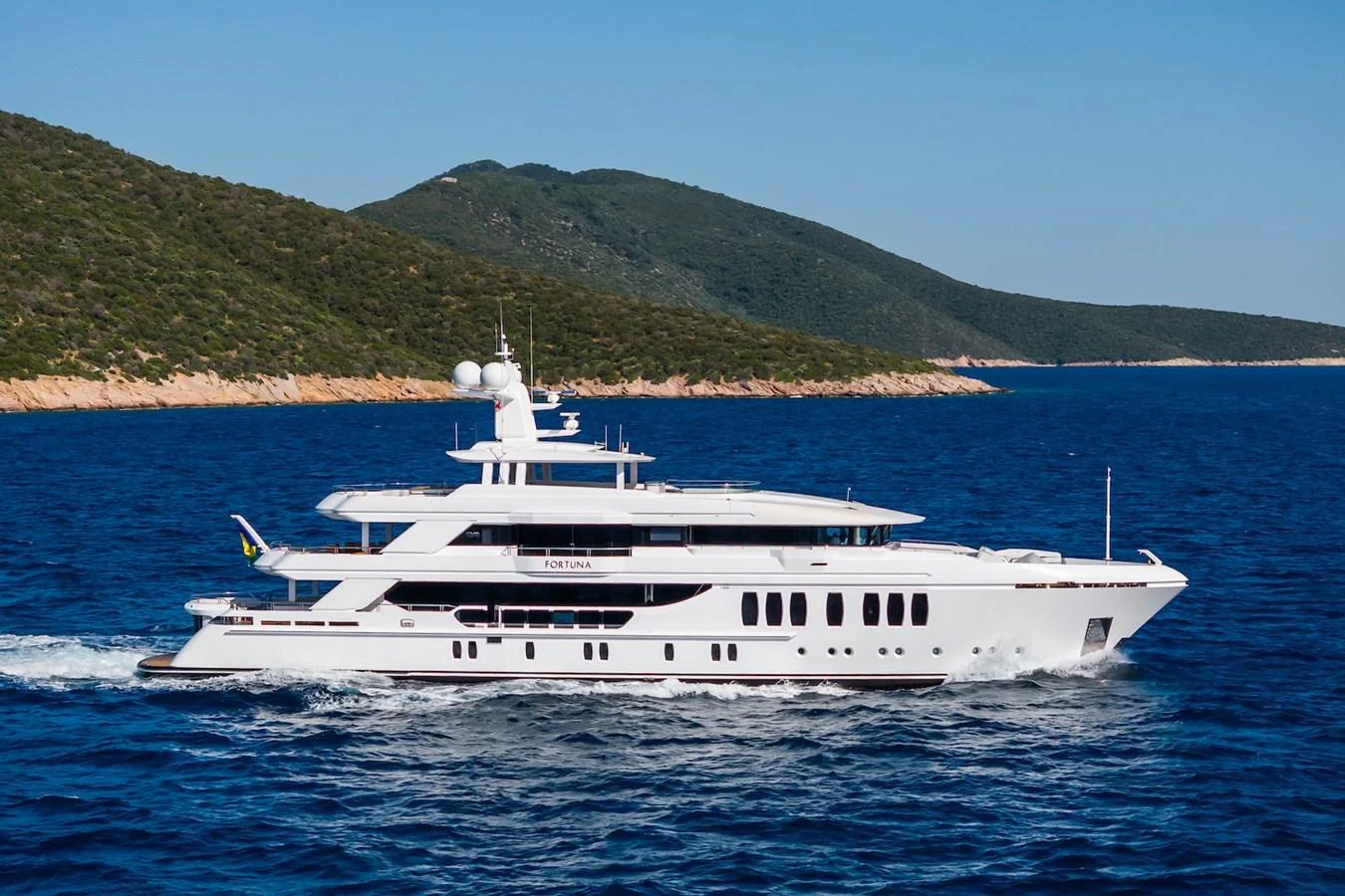 a white yacht on the water aboard FORTUNA Yacht for Sale