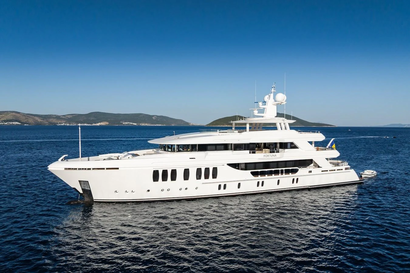 a white yacht in the water aboard FORTUNA Yacht for Sale