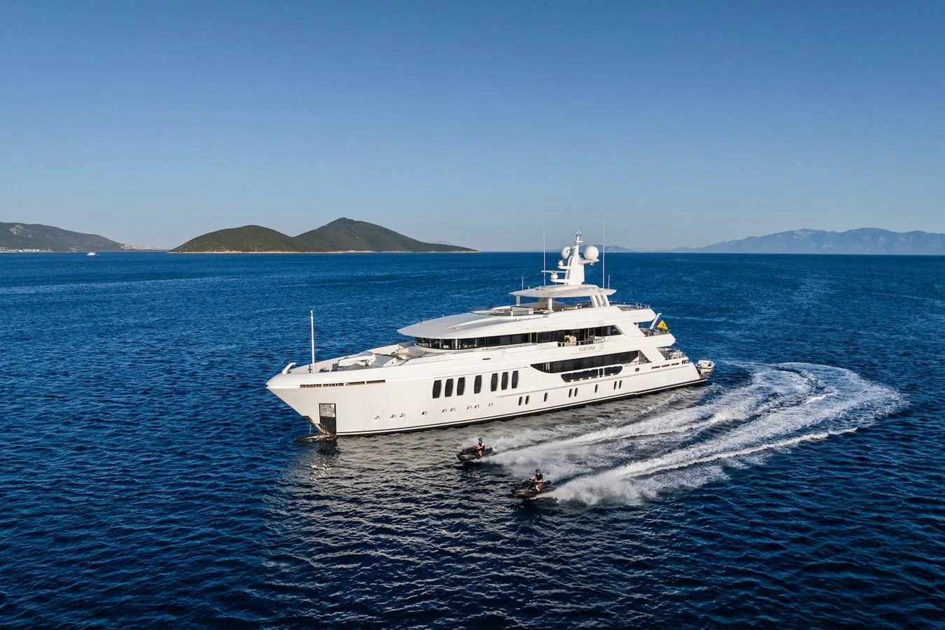 a white boat on the water aboard FORTUNA Yacht for Sale
