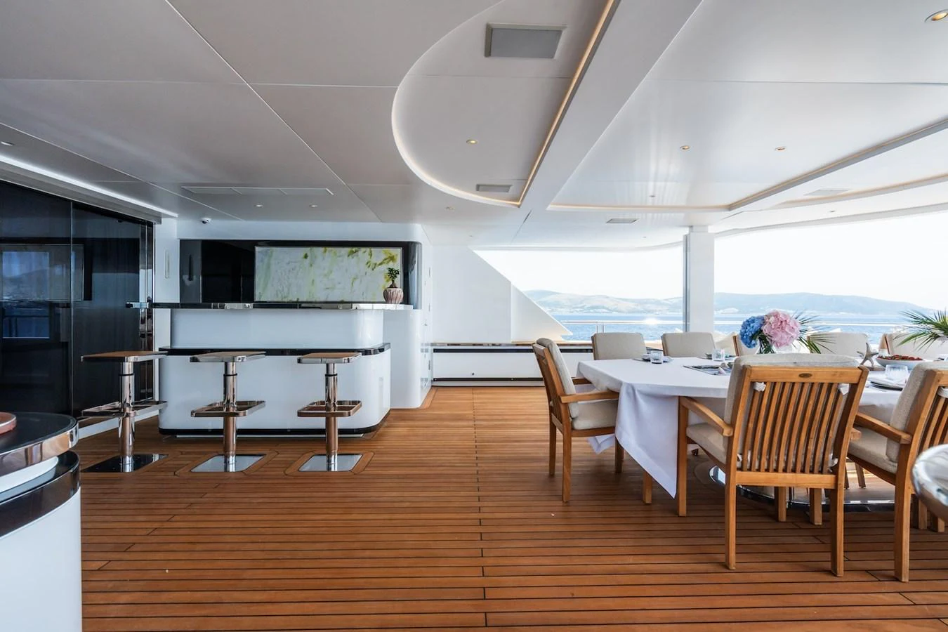 a room with tables and chairs aboard FORTUNA Yacht for Sale